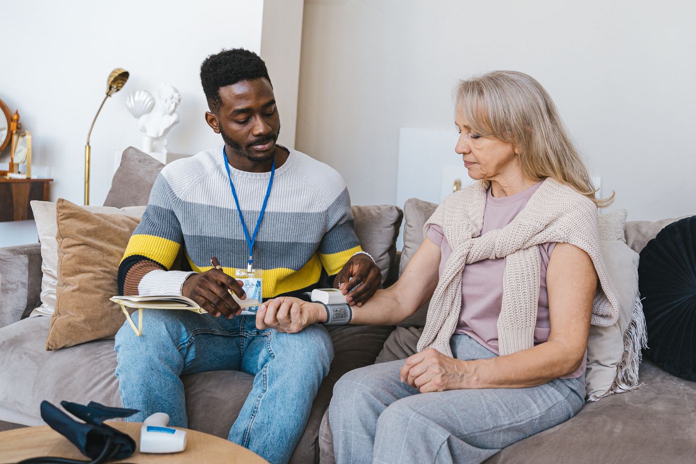 A Compass Care carer checking in on a client at home
